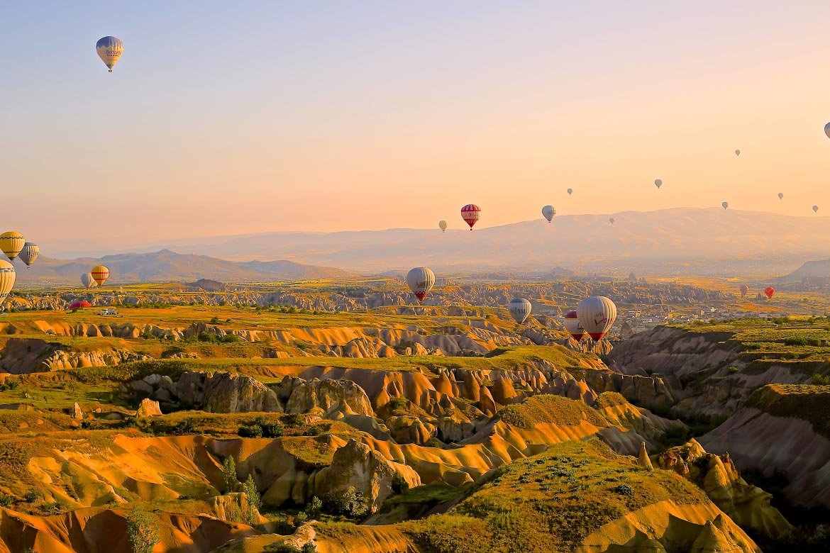 Scattered Hot Air Balloons Over Rock Formation