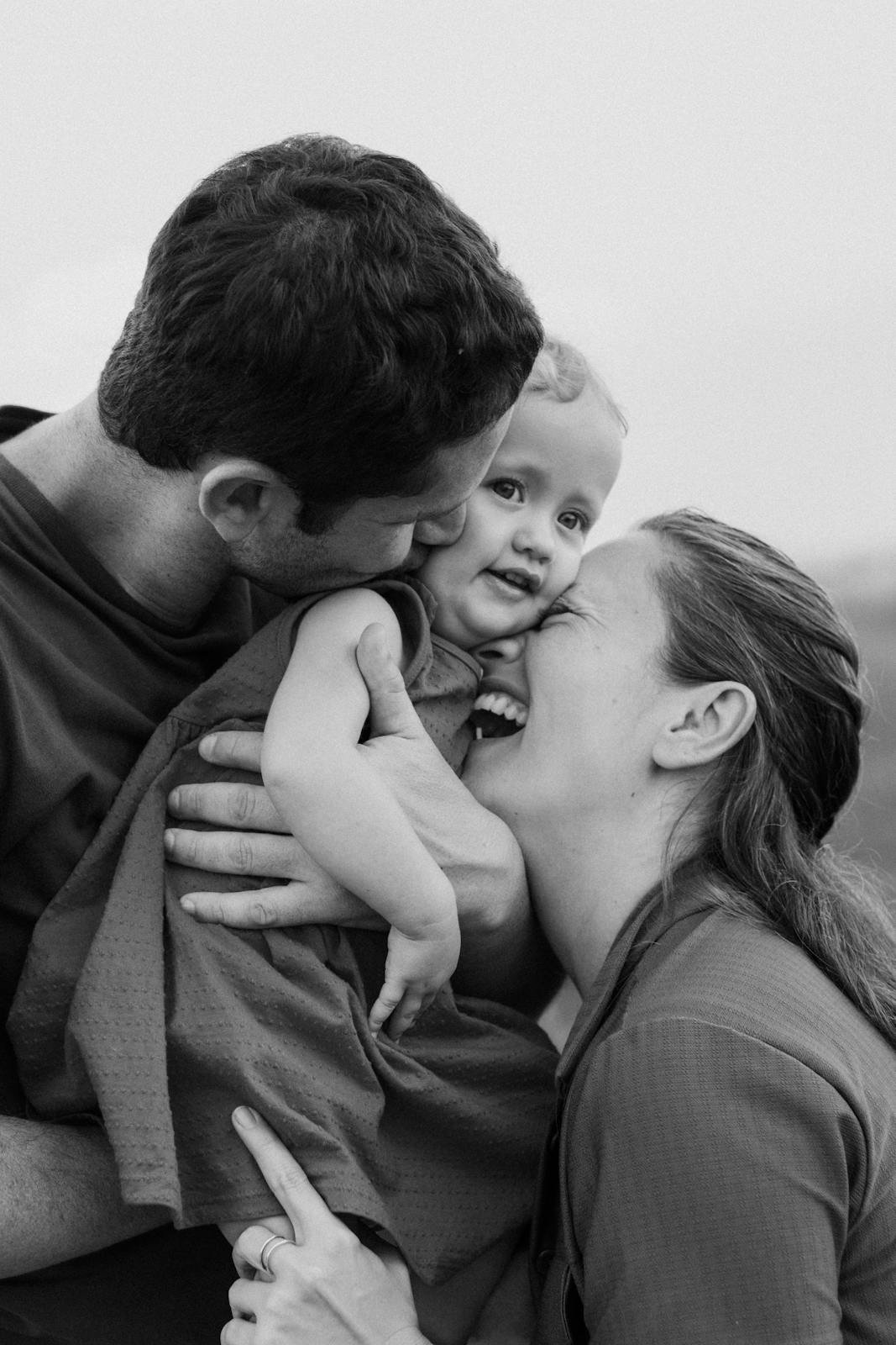Heartwarming black and white family moment showcasing parental love.