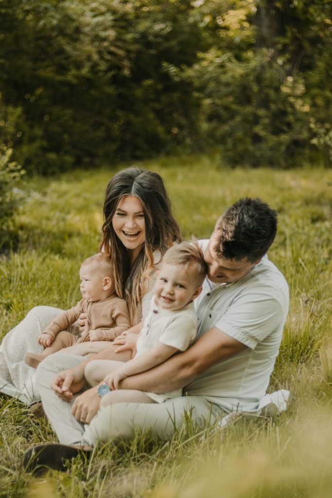 Candid family portrait capturing parent-child bonding in a serene outdoor setting.